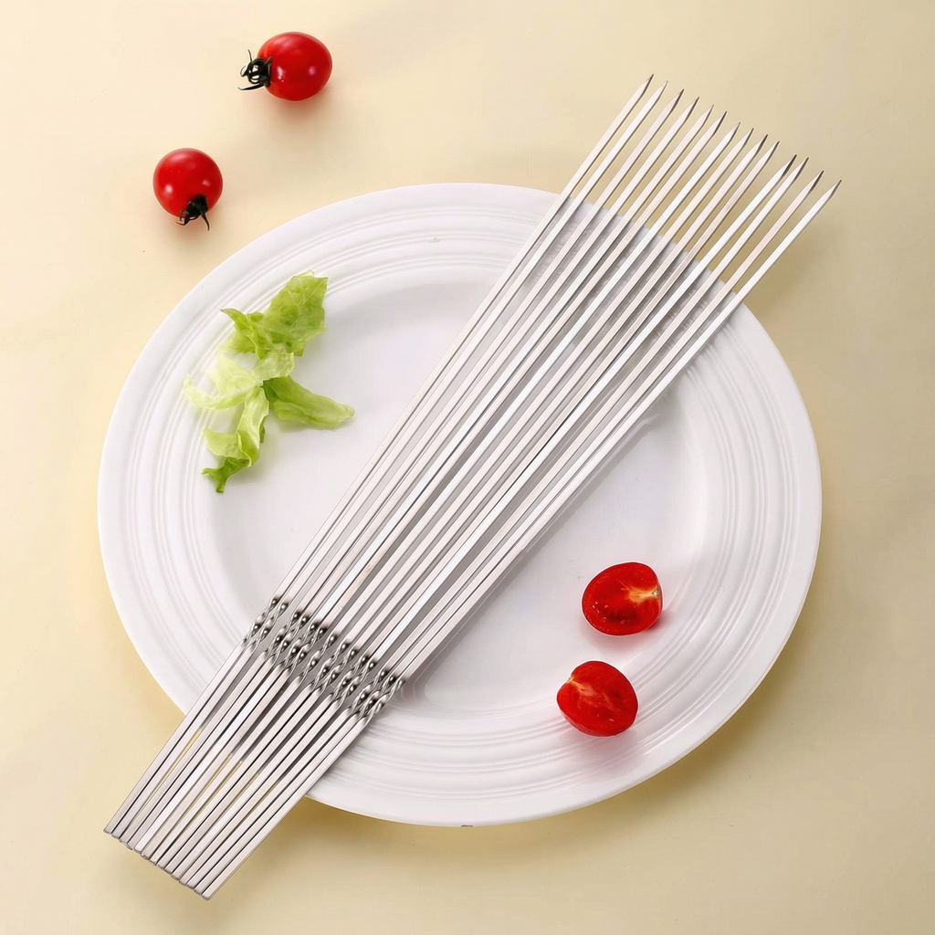 Bețele de inox strânse mănunchi pe o farfurie albă, lângă roșii cherry