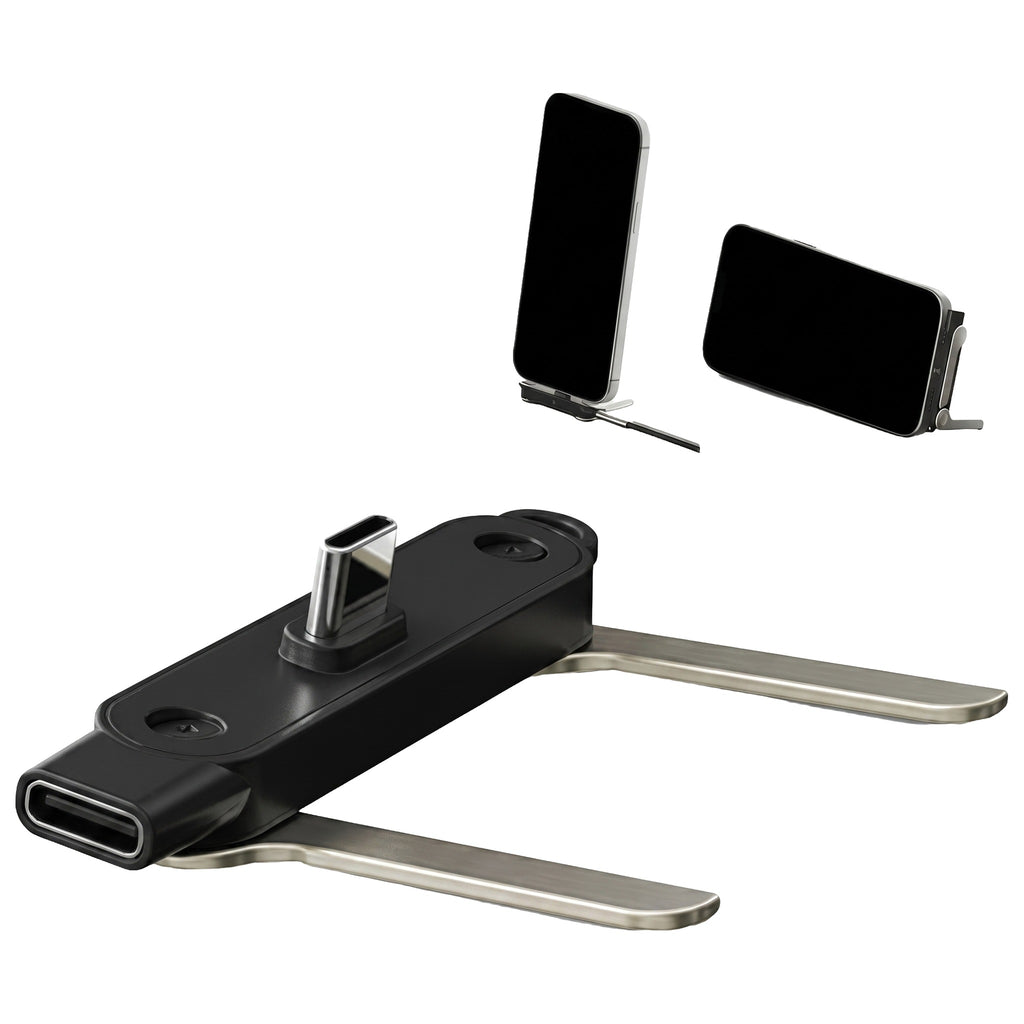 Adaptor Type-C negru cu picioare metalice desfăcute, folosit ca suport pentru telefon, pe fundal alb